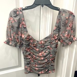 Floral ruched grey shirt with puffy sleeves.